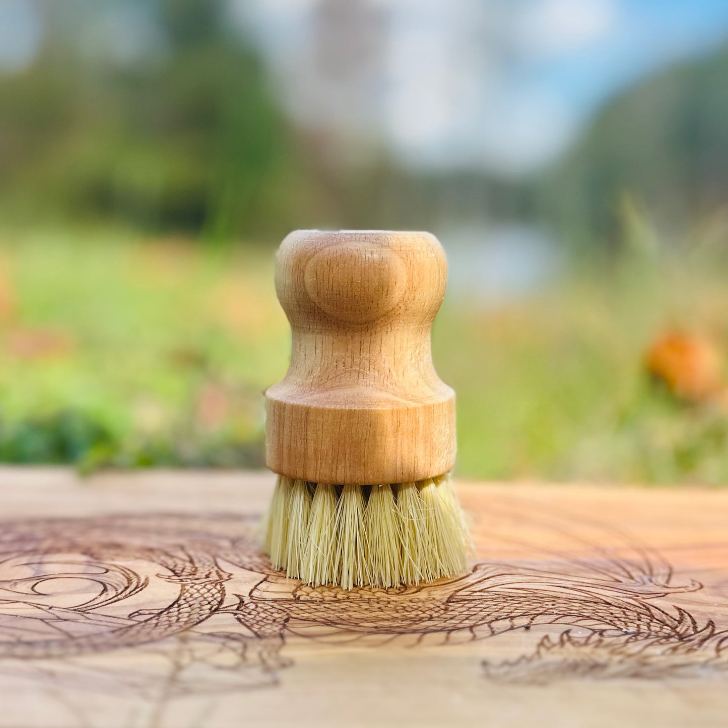 Wooden brush with bristles on a wooden surface outdoors