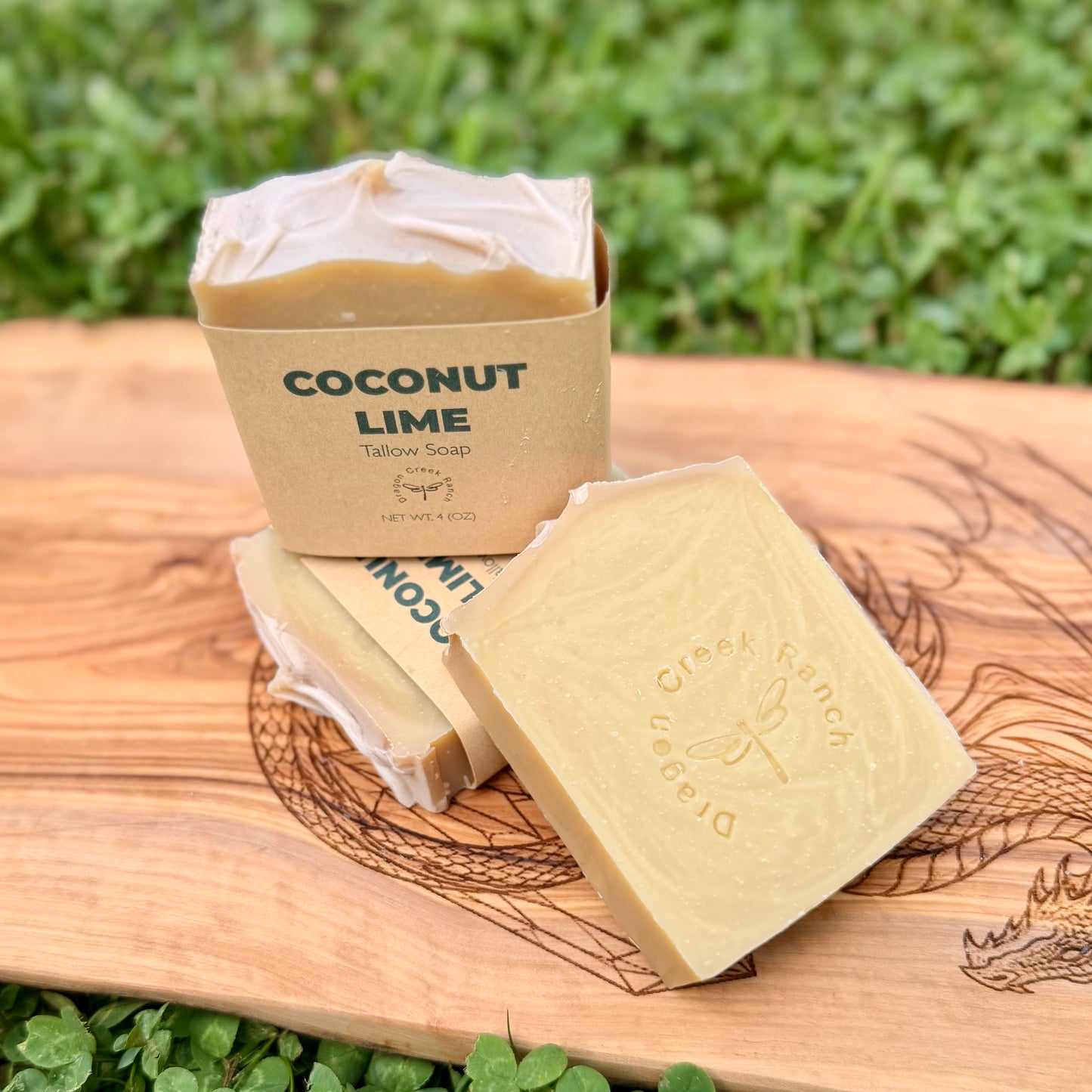 Coconut Lime soap bars and packaging on a wooden board with a natural background
