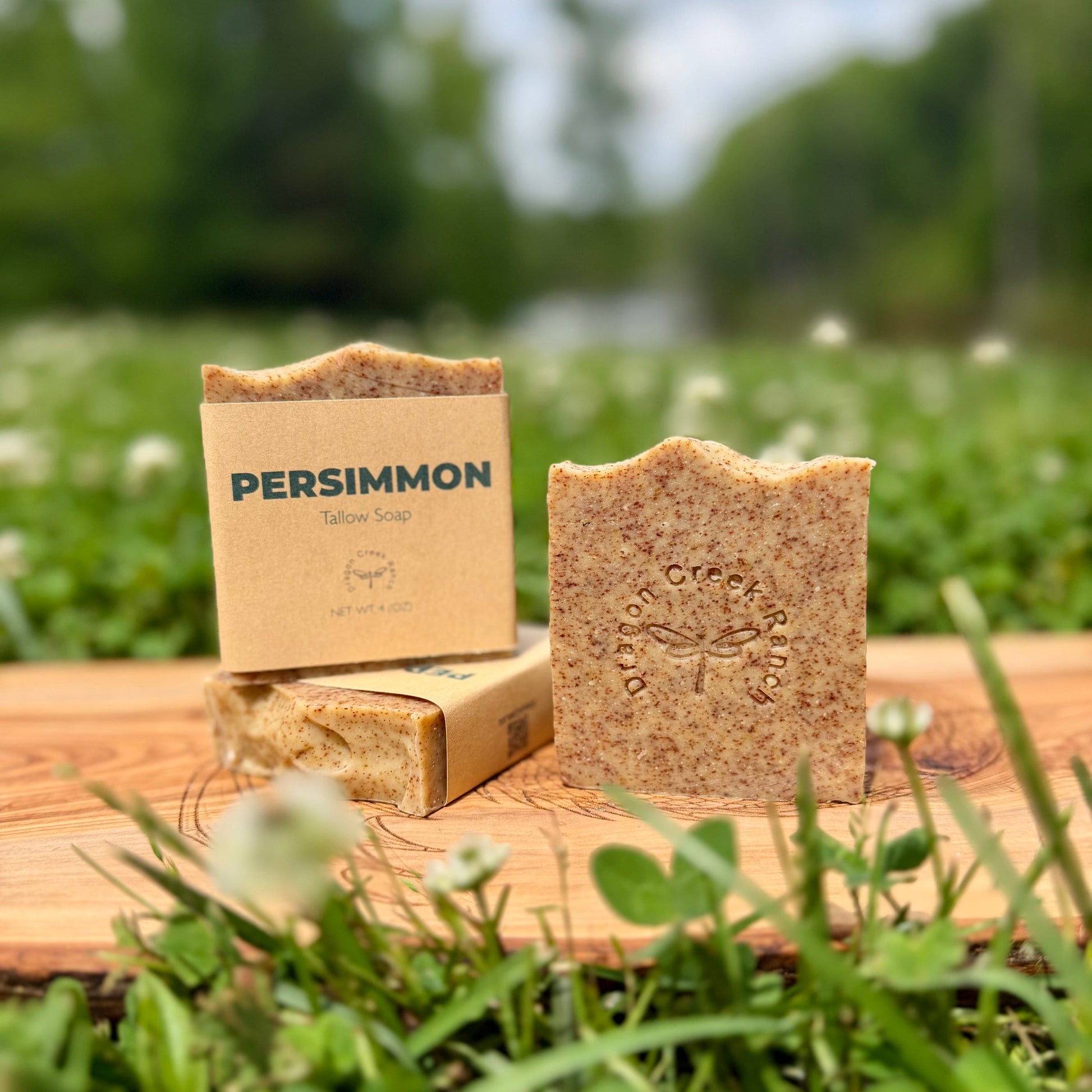 Persimmon soap bar and packaging on a wooden surface with a natural background